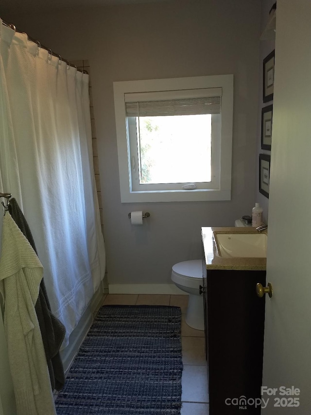 full bathroom featuring toilet, vanity, tile patterned floors, and shower / tub combo with curtain