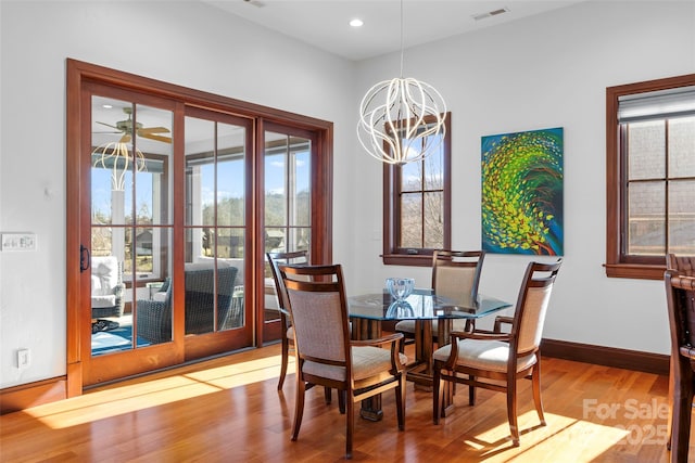 dining space featuring hardwood / wood-style floors and a notable chandelier