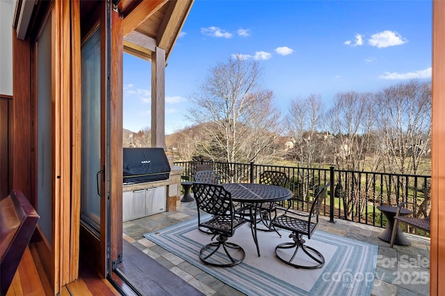 wooden deck with a mountain view and an outdoor kitchen