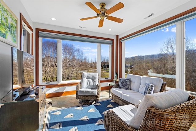 sunroom with ceiling fan