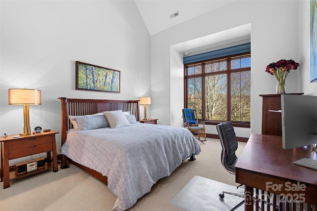 bedroom featuring high vaulted ceiling and light colored carpet