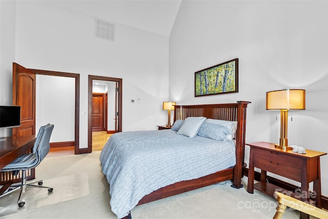 bedroom featuring light carpet and high vaulted ceiling