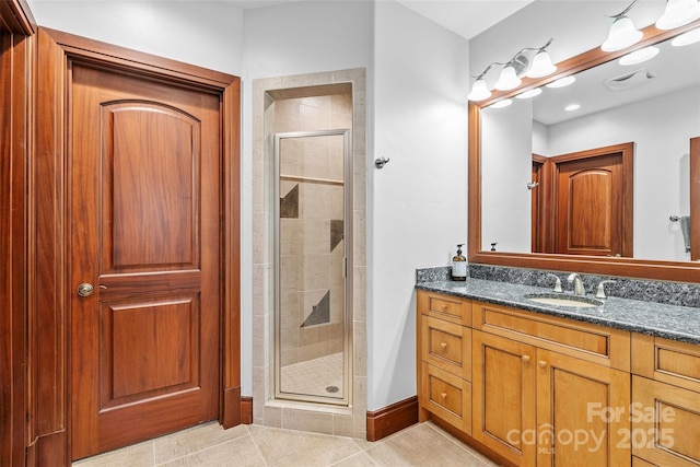 bathroom with tile patterned floors, vanity, and a shower with shower door