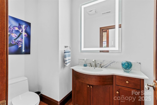 bathroom with vanity and toilet