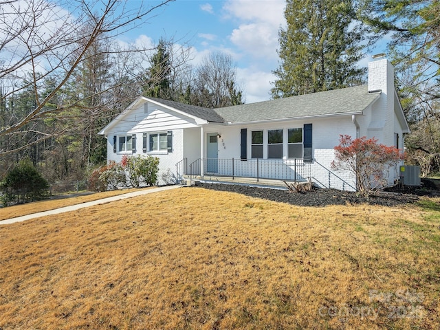 ranch-style house with a front yard, a porch, and cooling unit