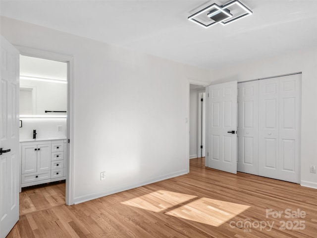 unfurnished bedroom featuring a closet and light hardwood / wood-style floors