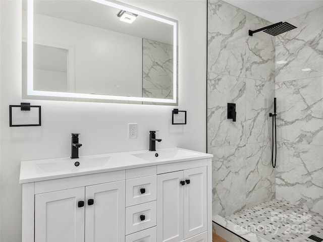 bathroom with vanity and tiled shower