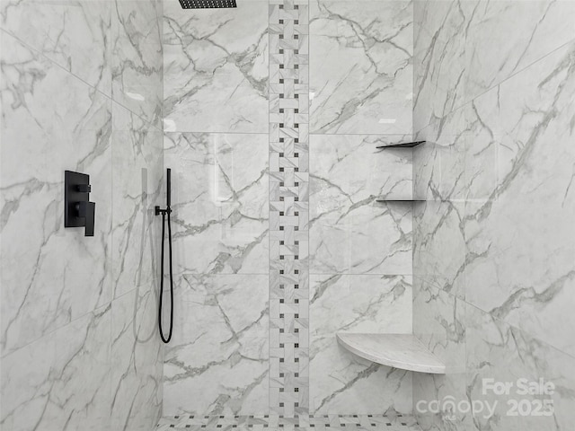 bathroom with tiled shower