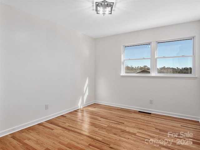 spare room featuring light hardwood / wood-style floors