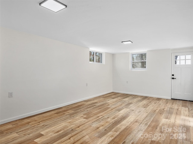 basement with light hardwood / wood-style flooring