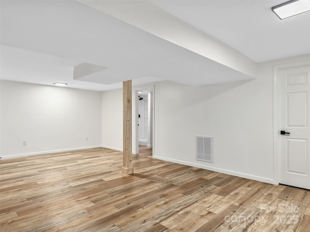 basement with light hardwood / wood-style floors