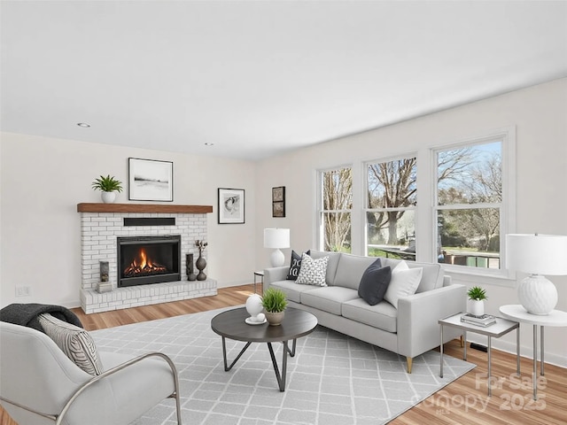 living room featuring a fireplace and light hardwood / wood-style flooring