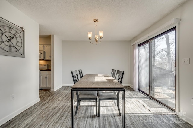 dining area featuring a textured ceiling, a chandelier, and hardwood / wood-style flooring