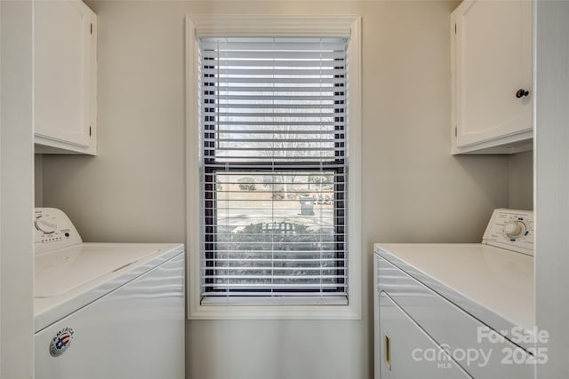 laundry room featuring cabinets and washing machine and clothes dryer