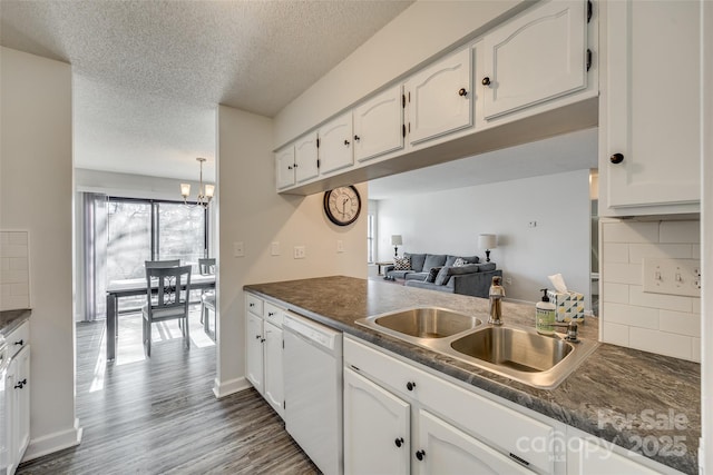 kitchen with sink, white cabinets, white dishwasher, decorative backsplash, and dark wood-type flooring