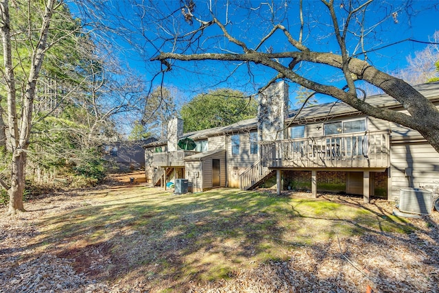 rear view of property with a yard, central AC, and a deck