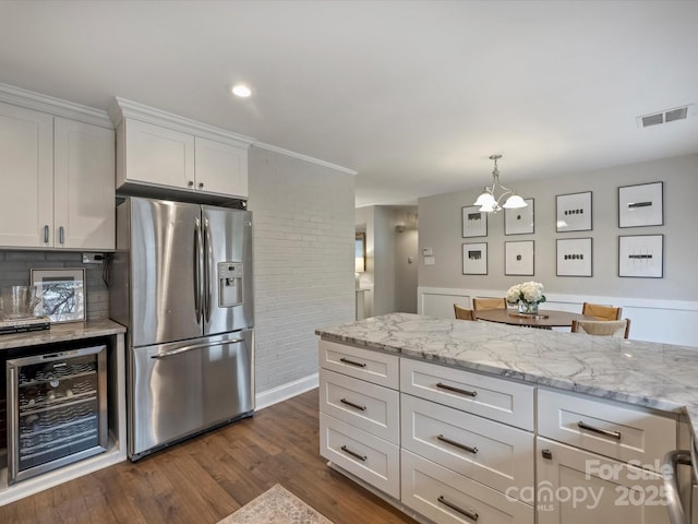 kitchen with stainless steel fridge, dark hardwood / wood-style floors, wine cooler, light stone countertops, and white cabinets