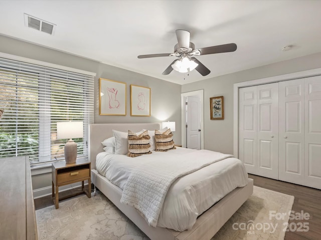 bedroom featuring ceiling fan, light hardwood / wood-style floors, and a closet