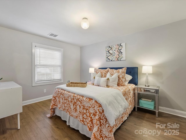 bedroom with dark wood-type flooring