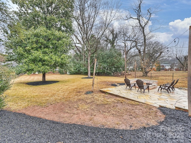 view of yard featuring a patio and an outdoor fire pit