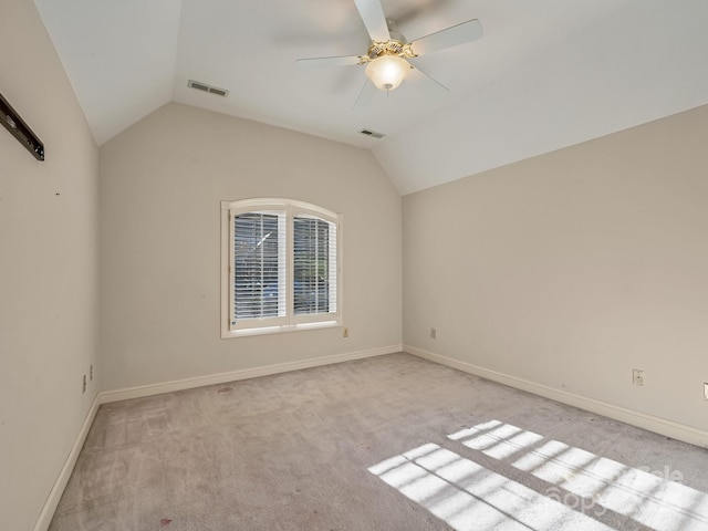 empty room with light colored carpet, ceiling fan, and lofted ceiling