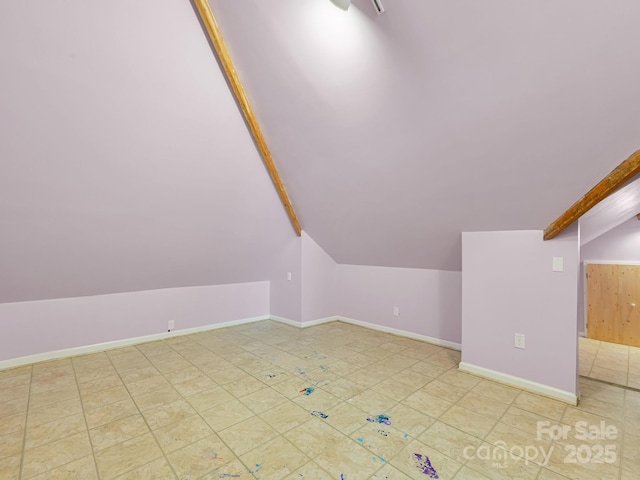 bonus room with lofted ceiling with beams