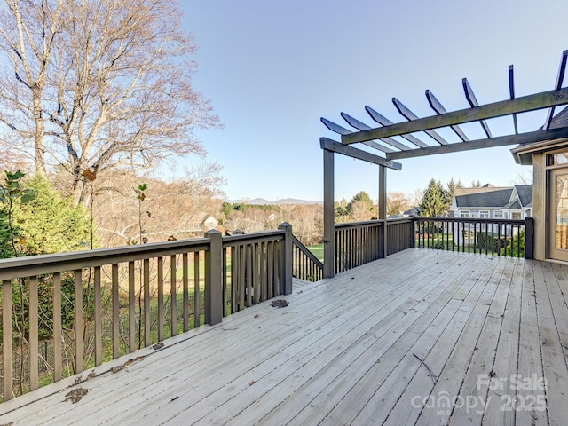 wooden deck featuring a pergola