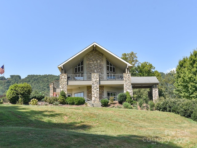 back of house with a balcony and a lawn