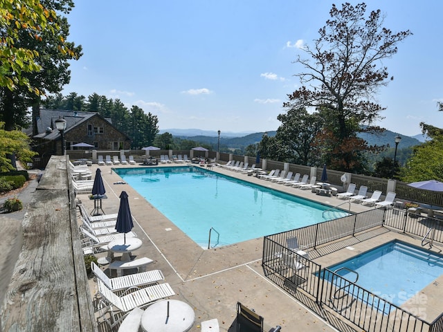 view of pool with a mountain view and a patio