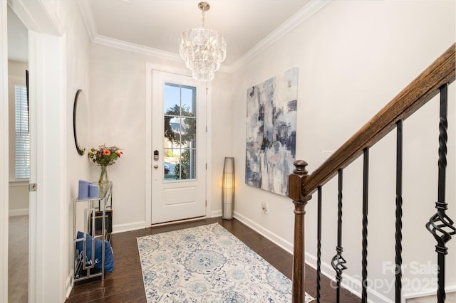 entrance foyer featuring dark hardwood / wood-style flooring, a chandelier, and crown molding