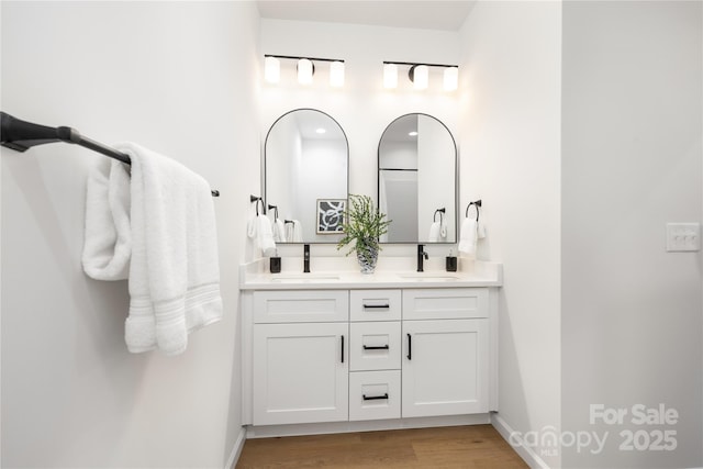 bathroom with hardwood / wood-style floors and vanity