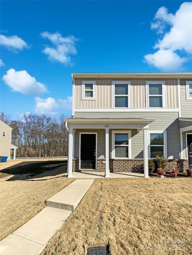 view of property with a front lawn and covered porch