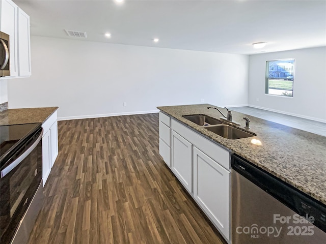 kitchen featuring stainless steel appliances, dark wood-type flooring, sink, stone counters, and white cabinetry