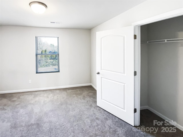 unfurnished bedroom featuring carpet flooring and a closet