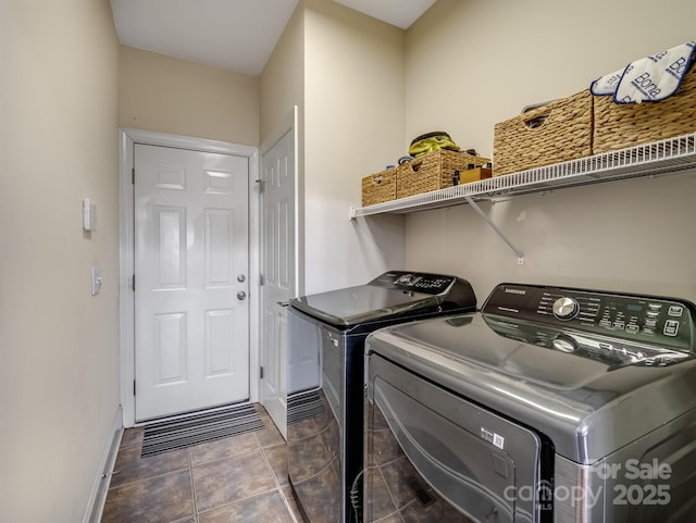 laundry area with tile patterned flooring, laundry area, washer and clothes dryer, and baseboards