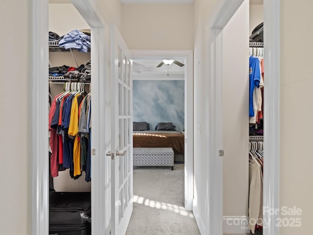 corridor featuring carpet floors and french doors