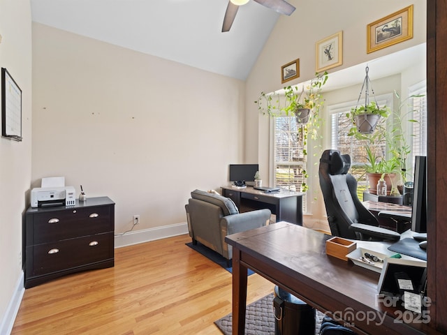 office area with light wood finished floors, ceiling fan, baseboards, and high vaulted ceiling