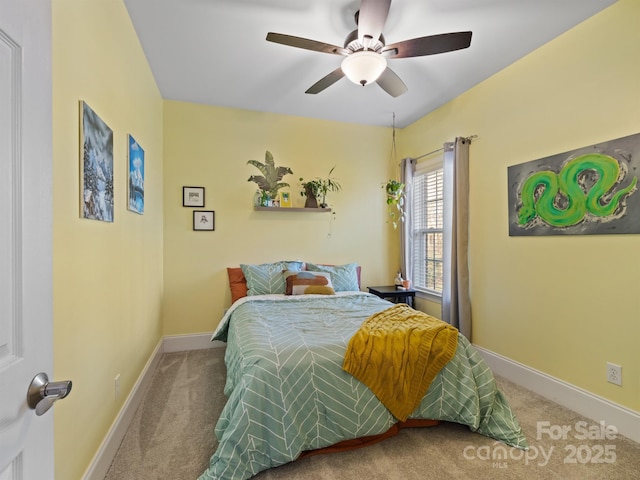 bedroom with a ceiling fan, carpet flooring, and baseboards