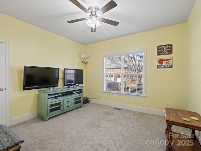 carpeted living room with baseboards, visible vents, and ceiling fan