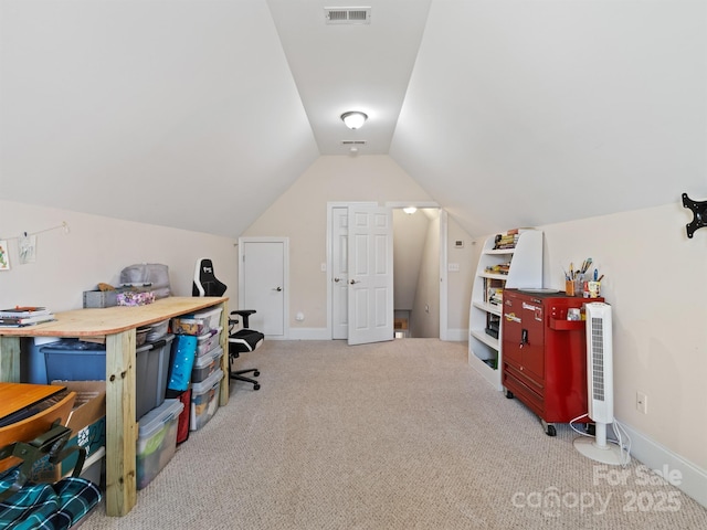 carpeted office space with lofted ceiling, baseboards, and visible vents