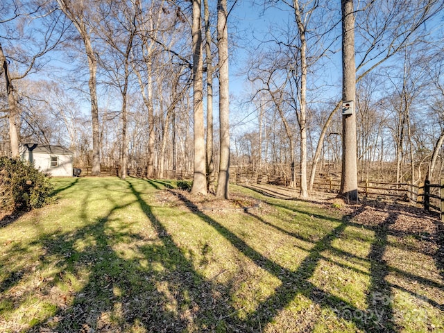 view of yard with an outbuilding and fence