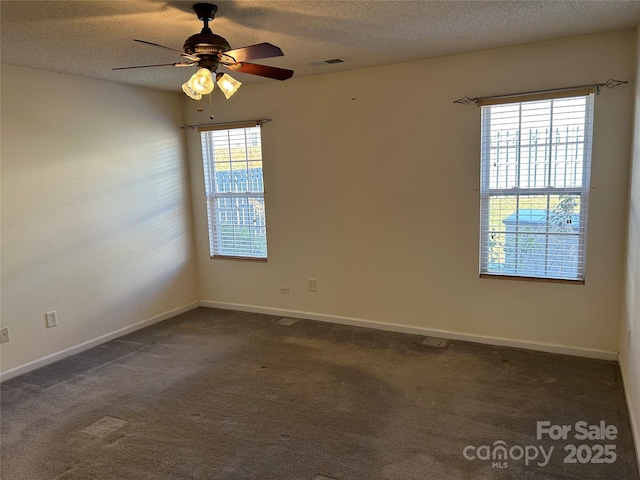 carpeted spare room featuring a textured ceiling and ceiling fan