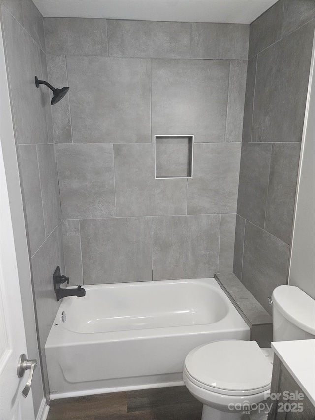 bathroom featuring tiled shower / bath and toilet