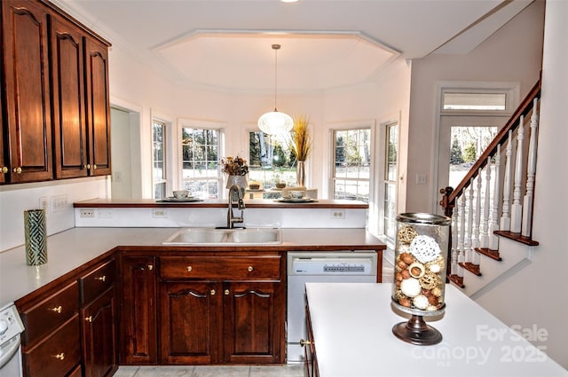 kitchen with kitchen peninsula, dishwasher, hanging light fixtures, and sink