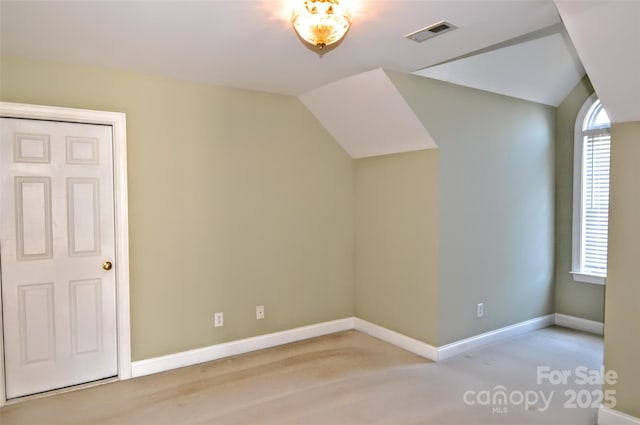 additional living space featuring vaulted ceiling