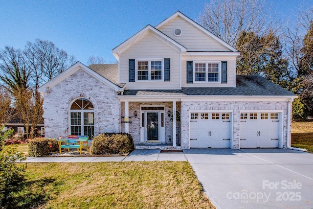 front of property with a garage and a front lawn