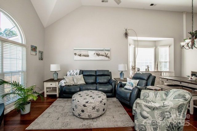 living room with dark hardwood / wood-style flooring and vaulted ceiling