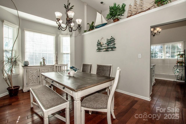 dining space with a high ceiling, dark wood-type flooring, and a notable chandelier