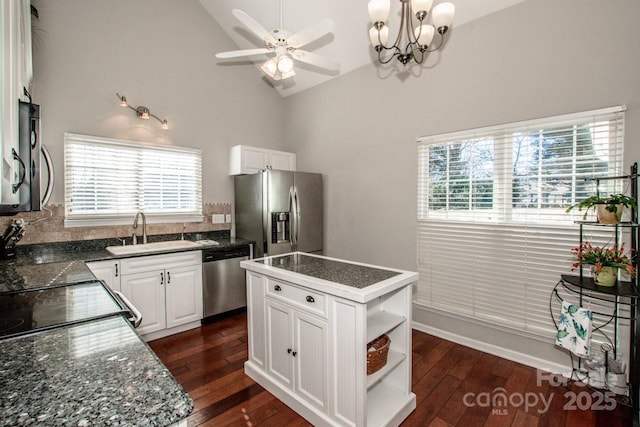 kitchen featuring white cabinets, a kitchen island, sink, and appliances with stainless steel finishes