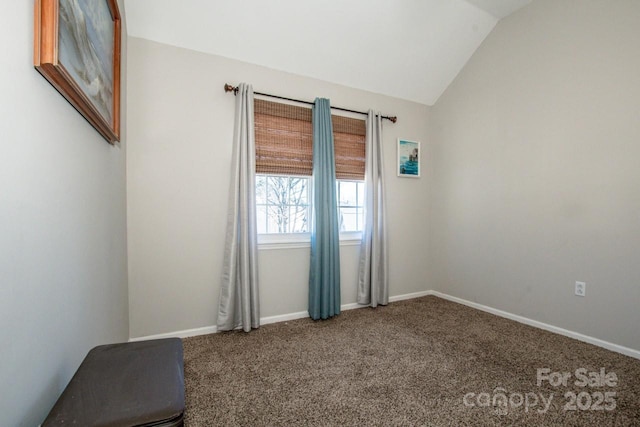 unfurnished room featuring carpet and vaulted ceiling